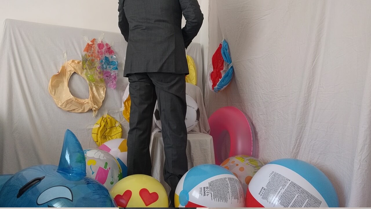 2 - Man in suit preparing to pop beach balls