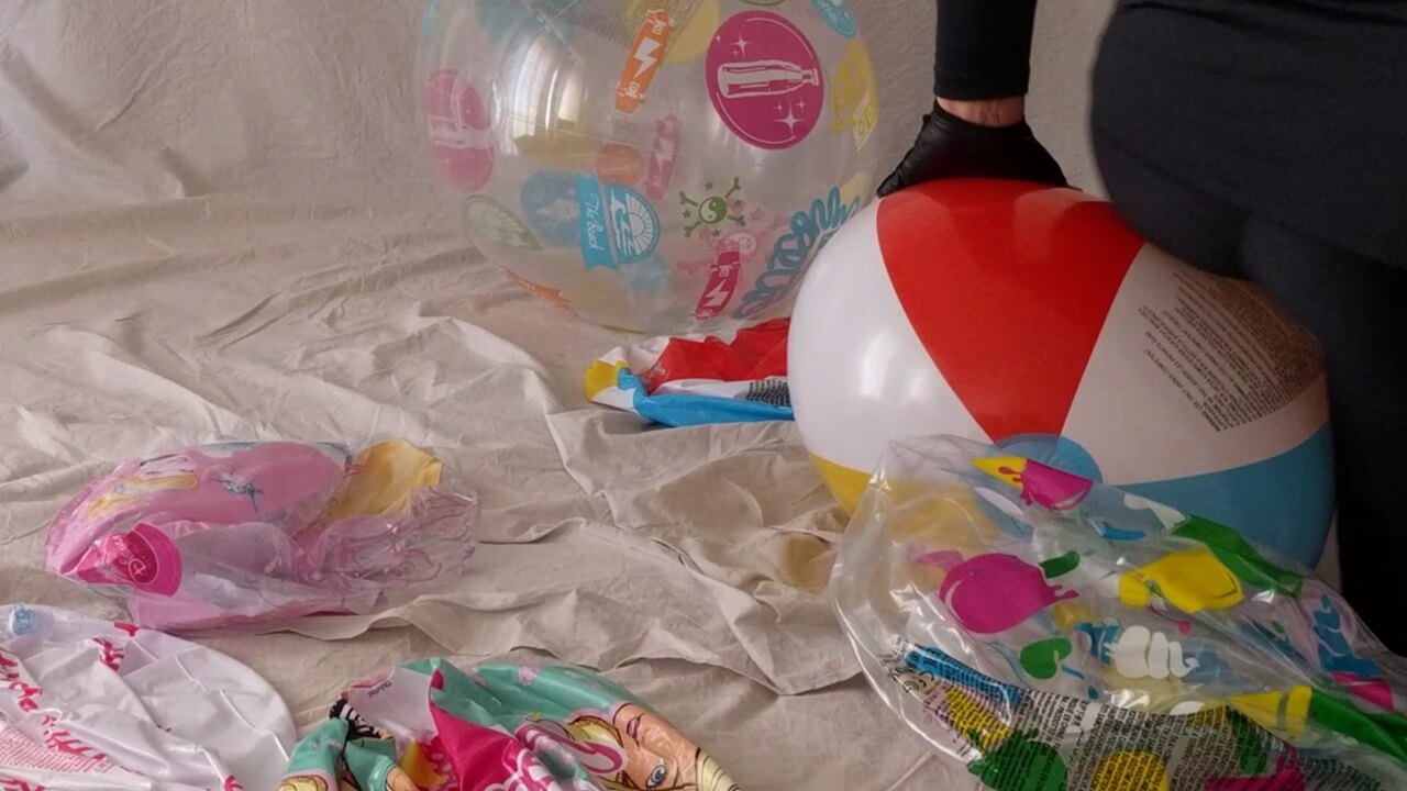 I'm preparing to sit to pop this beach ball on my bed