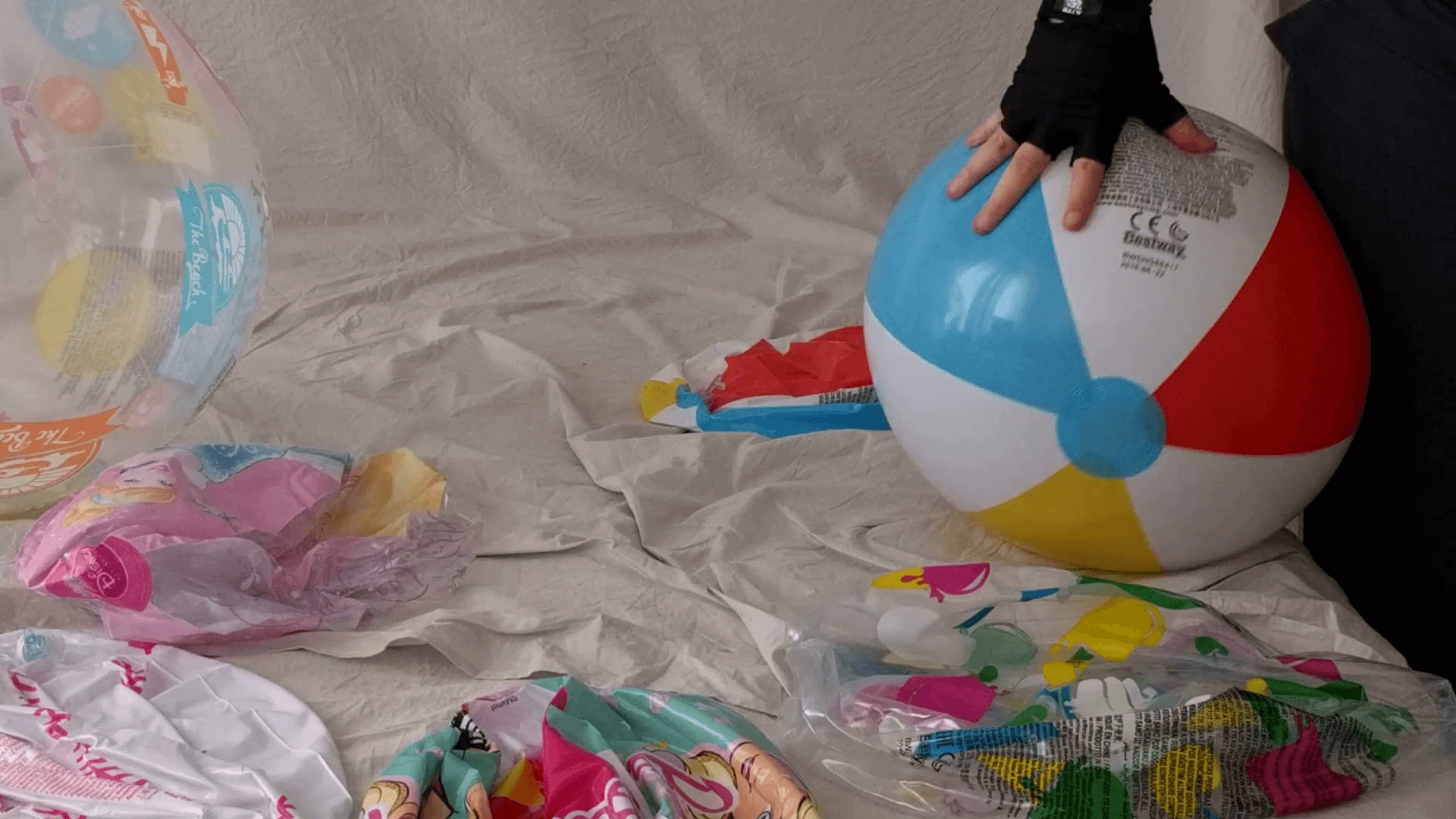 Sit popping a classic 6 panel 20-inch beach ball on the bed