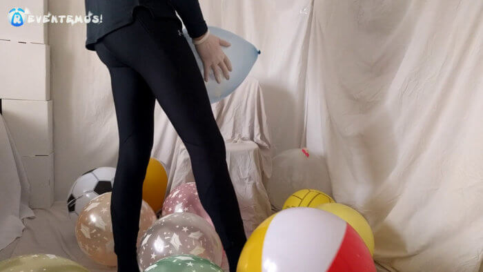 702 . Sit popping small balloons on a chair in leggings