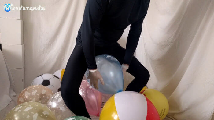 703 . Sit popping small balloons on a chair in leggings