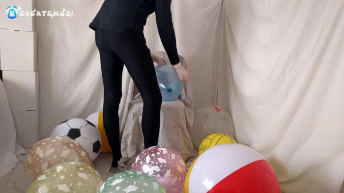 704 . Sit popping small balloons on a chair in leggings