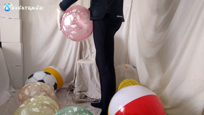 707 . Sit popping small balloons on a chair in leggings