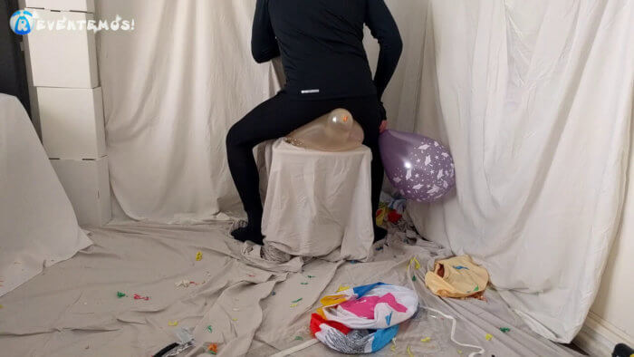 719 . Sit popping small balloons on a chair in leggings