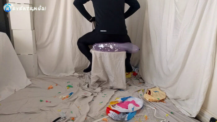 721 . Sit popping small balloons on a chair in leggings