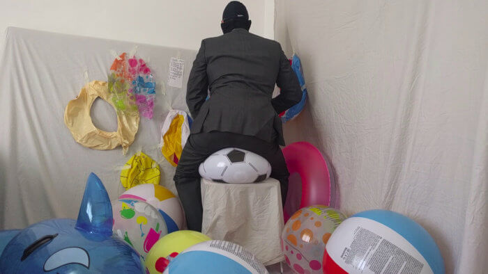 802. Sit popping beach balls in a suit after work