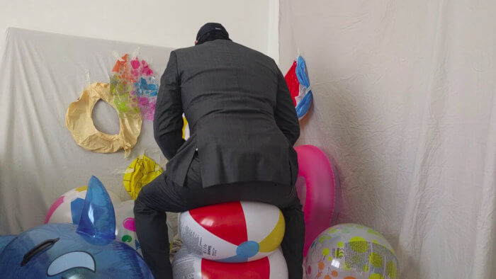 805. Sit popping beach balls in a suit after work