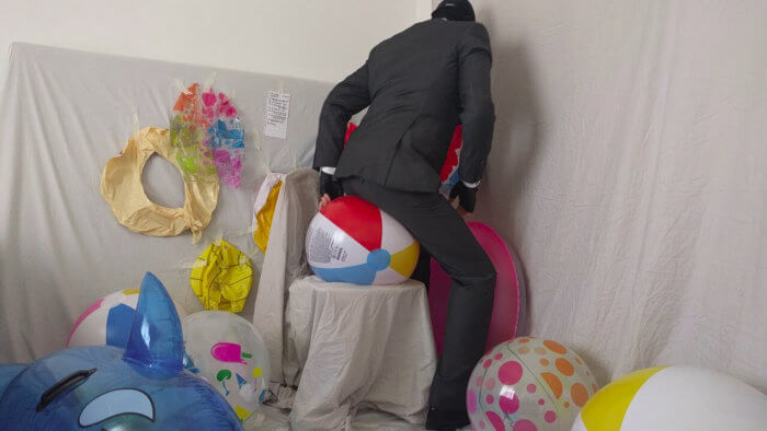 806. Sit popping beach balls in a suit after work