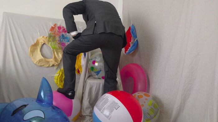 808. Sit popping beach balls in a suit after work