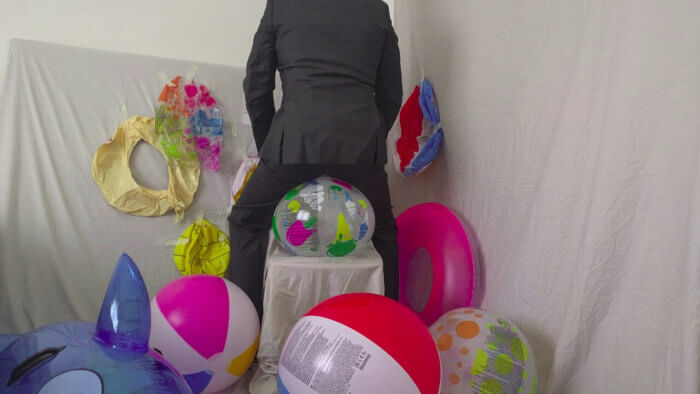 809. Sit popping beach balls in a suit after work