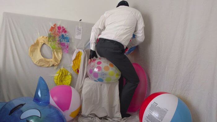 810. Sit popping beach balls in a suit after work