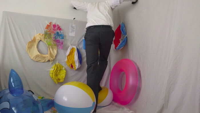 812. Sit popping beach balls in a suit after work