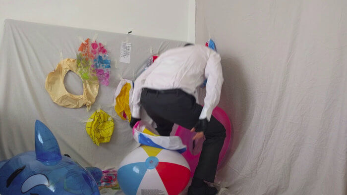 813. Sit popping beach balls in a suit after work