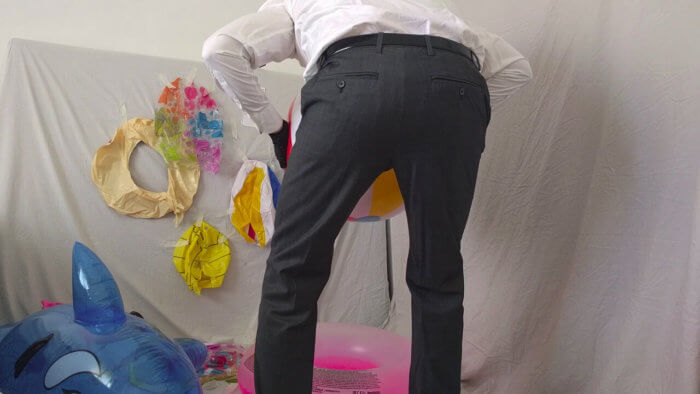 814. Sit popping beach balls in a suit after work