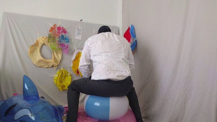 817. Sit popping beach balls in a suit after work