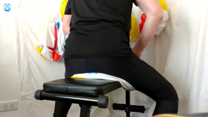 912. Sit popping and deflating beach balls on a workout bench