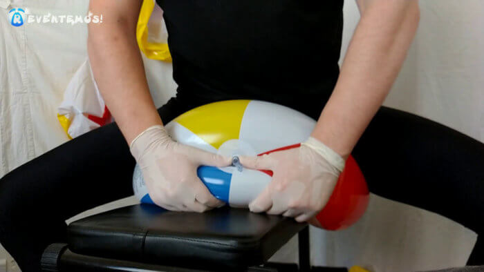 914. Sit popping and deflating beach balls on a workout bench