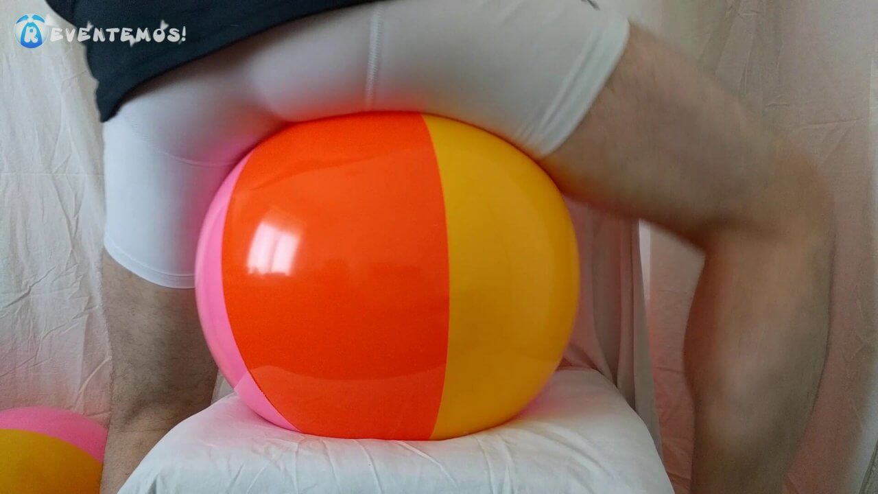 1001. Sit popping small beach balls on a chair in underwear