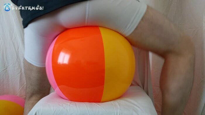 1001. Sit popping small beach balls on a chair in underwear