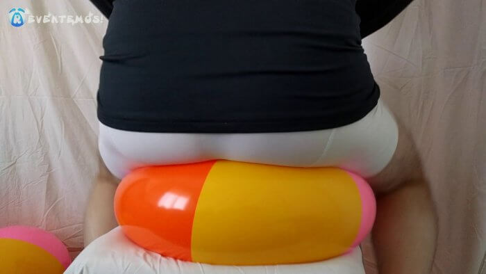 1002. Sit popping small beach balls on a chair in underwear