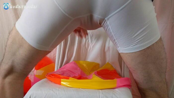 1004. Sit popping small beach balls on a chair in underwear