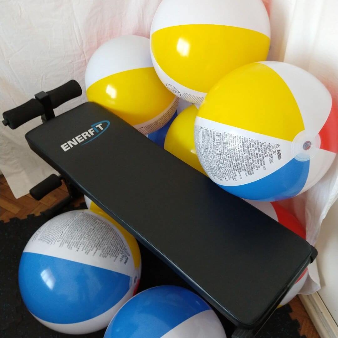 A bench with beach balls around
