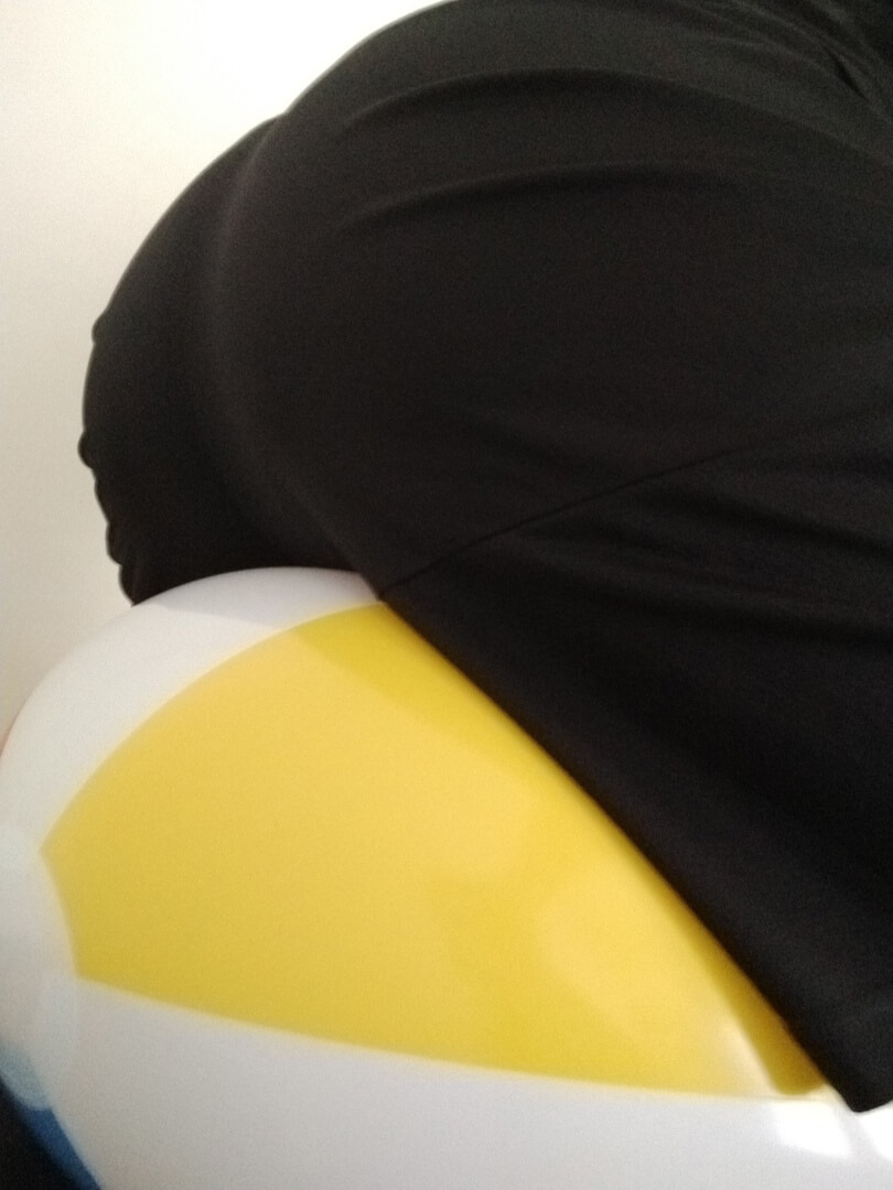 Riding a beach ball from behind in sweatpants