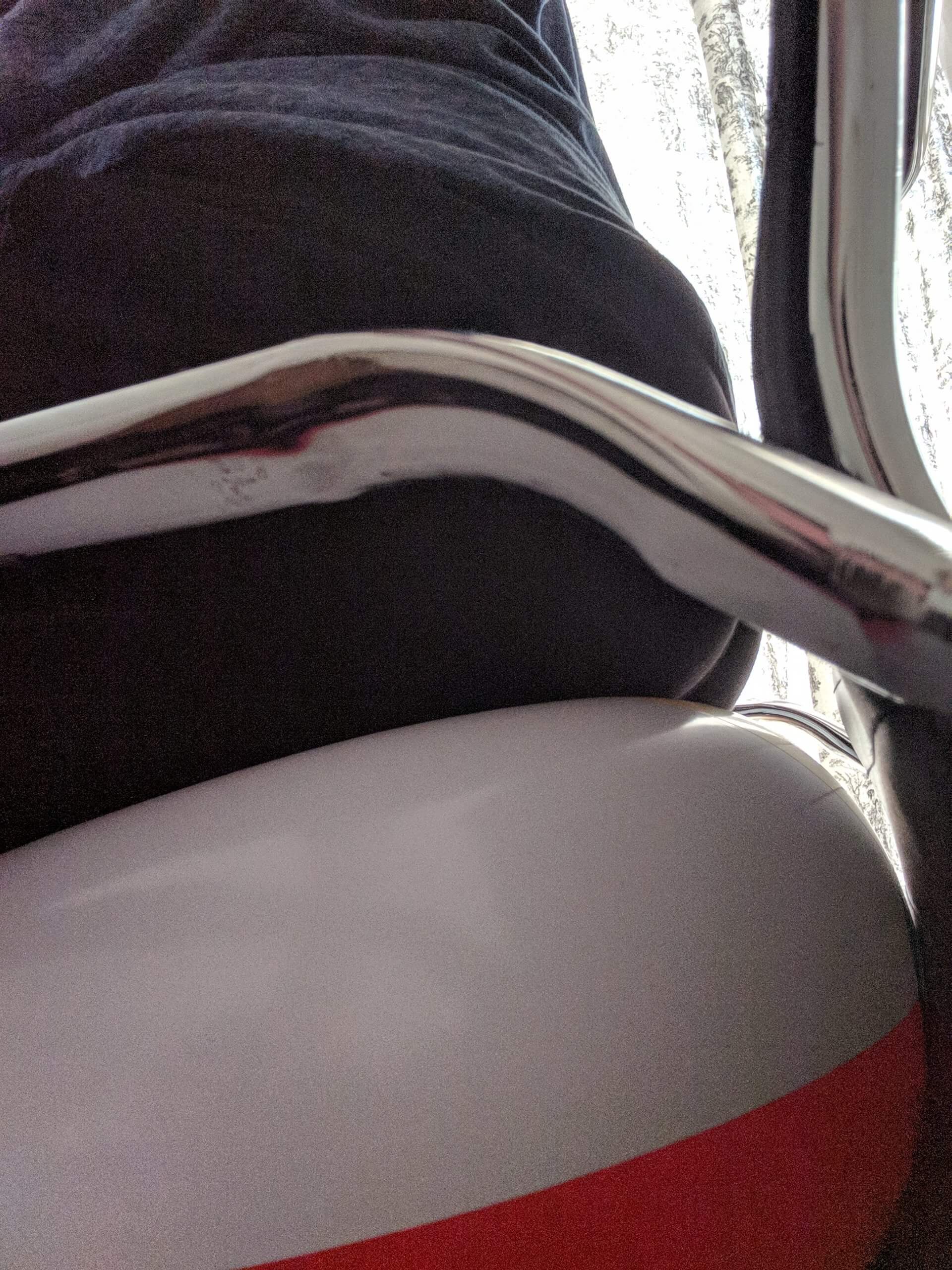 Sitting on a beach ball in black trousers on a chair